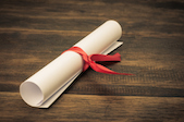 Parchment diploma scroll on wood background